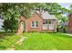 Charming brick home with a well-maintained lawn and arched doorway at 949 Hope Sw Dr, Atlanta, GA 30310