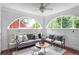 Bright sunroom with large arched windows and comfortable seating at 949 Hope Sw Dr, Atlanta, GA 30310