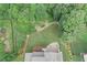A bird's-eye view showcases a home, patio, and beautiful, wooded backyard at 125 Registry Ln, Canton, GA 30115