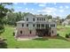 An expansive backyard with a raised patio, stairs, and a screened-in porch at 125 Registry Ln, Canton, GA 30115