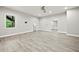 Finished basement with light wood-look flooring, bright lighting and an exit door to stairs at 125 Registry Ln, Canton, GA 30115