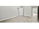 Open basement space with light wood-look flooring, and a doorway with backyard access at 125 Registry Ln, Canton, GA 30115