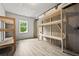 Unfinished basement with wood-look flooring, exposed beams, and natural light from the window at 125 Registry Ln, Canton, GA 30115