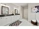 Well-lit bathroom with double vanity, dark countertops, and tile flooring at 125 Registry Ln, Canton, GA 30115