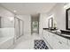 Elegant bathroom with white cabinets, dual sinks, dark countertops, and a tiled shower behind glass at 125 Registry Ln, Canton, GA 30115