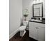Compact powder room with white vanity, dark countertop, and modern fixtures at 125 Registry Ln, Canton, GA 30115