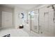 Bright bathroom featuring a separate tub and shower with white marbled tile and a neutral color palette at 125 Registry Ln, Canton, GA 30115