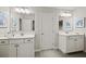 Bright bathroom featuring dual sink vanities with white cabinets and modern fixtures at 125 Registry Ln, Canton, GA 30115