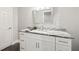 A bathroom offers a modern vanity, granite countertops, a decorative mirror, and neutral paint at 125 Registry Ln, Canton, GA 30115