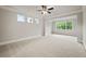 Large, empty bedroom with neutral carpet and paint, featuring multiple windows for natural light at 125 Registry Ln, Canton, GA 30115