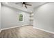 Bright bedroom features wood-look floors, a window, neutral paint, and built in shelves at 125 Registry Ln, Canton, GA 30115