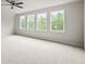 Large bedroom with carpet, ceiling fan, and four large windows bringing in natural light at 125 Registry Ln, Canton, GA 30115