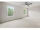 Spacious bedroom with ceiling fan and large windows showing greenery outside at 125 Registry Ln, Canton, GA 30115