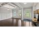 Bright foyer with hardwood floors, wainscoting, stylish lamps, and an elegant coffered ceiling at 125 Registry Ln, Canton, GA 30115