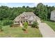 Lovely stone home with well-maintained landscaping, a lush lawn and long driveway at 125 Registry Ln, Canton, GA 30115