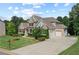 Desirable home with attached garage, manicured lawn, brick and cement driveway and walkway at 125 Registry Ln, Canton, GA 30115