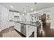 Open kitchen with a large island, stainless steel appliances, and view of the living room fireplace at 125 Registry Ln, Canton, GA 30115