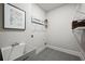 Functional laundry room with utility sink, shelving, and contemporary decor at 125 Registry Ln, Canton, GA 30115