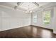 Bright, open-concept living room with coffered ceiling, hardwood floors, and wainscoting at 125 Registry Ln, Canton, GA 30115