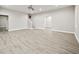 Open living room featuring light wood-look floors, neutral walls and stairway access at 125 Registry Ln, Canton, GA 30115