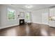 Cozy living room with a fireplace, hardwood flooring, and large windows offering natural light at 125 Registry Ln, Canton, GA 30115