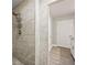 Bathroom featuring tiled walk-in shower, shower head, and a door to an additional room at 125 Registry Ln, Canton, GA 30115