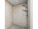 Spacious tiled shower complete with shower head and a built-in caddy for bath products at 125 Registry Ln, Canton, GA 30115