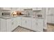 A wet bar is outfitted with white cabinetry, granite countertop, and decorative accents at 125 Registry Ln, Canton, GA 30115