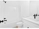 Bright bathroom featuring a white tub and vanity with sleek black fixtures at 19 Bridgemill Dr, Douglasville, GA 30134