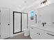 Modern bathroom featuring a glass-enclosed shower, tiled floors, and sleek fixtures at 19 Bridgemill Dr, Douglasville, GA 30134