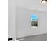 Clean, bright bedroom with a large window offering a neighborhood view at 19 Bridgemill Dr, Douglasville, GA 30134