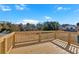 New wooden deck with wood railing and view of yard and trees at 19 Bridgemill Dr, Douglasville, GA 30134