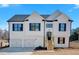 New two-story home with white siding, black shutters, and a two-car garage, enhanced by a bright blue sky at 19 Bridgemill Dr, Douglasville, GA 30134