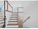 Inviting foyer with staircase, wood railings, and floors, leading to a bright, open living area at 19 Bridgemill Dr, Douglasville, GA 30134