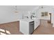 Kitchen island with sink and dishwasher, granite countertops, and modern lighting at 19 Bridgemill Dr, Douglasville, GA 30134