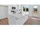 Bright kitchen features a modern island with a sink and black faucet, and stainless steel appliances at 19 Bridgemill Dr, Douglasville, GA 30134