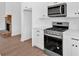 Updated kitchen with stainless steel range, granite countertops and white cabinets at 19 Bridgemill Dr, Douglasville, GA 30134