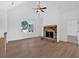 Sun-filled living area with stone fireplace, hardwood floors, and large windows at 19 Bridgemill Dr, Douglasville, GA 30134
