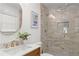 Bright bathroom featuring a walk-in shower with neutral-toned tiling and a white marble vanity with gold fixtures at 228 Mount Vernon Dr, Decatur, GA 30030
