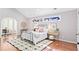 Vaulted ceiling primary bedroom with hardwood floors, a large window, and an adjacent sitting area at 228 Mount Vernon Dr, Decatur, GA 30030