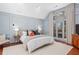 A primary bedroom with light blue paneled walls, a large window, and white carpet at 228 Mount Vernon Dr, Decatur, GA 30030