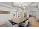 Light-filled dining room showcases a large wooden table and unique pendant lighting at 228 Mount Vernon Dr, Decatur, GA 30030