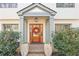 Charming entrance featuring a wooden door with a decorative wreath and potted plants at 228 Mount Vernon Dr, Decatur, GA 30030