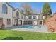 Exterior view of a home's swimming pool with hot tub, surrounded by grass and a patio at 228 Mount Vernon Dr, Decatur, GA 30030