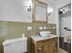 Bathroom featuring green wall tiles and a vessel sink on an antique vanity at 315 Renae, Marietta, GA 30060