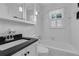 Bright bathroom featuring white tile, a black countertop, and a single window for natural light at 315 Renae, Marietta, GA 30060