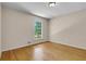 This bedroom features hardwood floors, neutral paint, and a sunny window at 315 Renae, Marietta, GA 30060