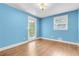 This light-blue bedroom features hardwood floors, a window and a door at 315 Renae, Marietta, GA 30060
