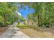 A paved driveway leads to this inviting two-story house with mature trees and lush green lawn at 315 Renae, Marietta, GA 30060