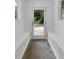 Hallway with a glass door leading to the backyard, accented by white trim and natural light at 315 Renae, Marietta, GA 30060